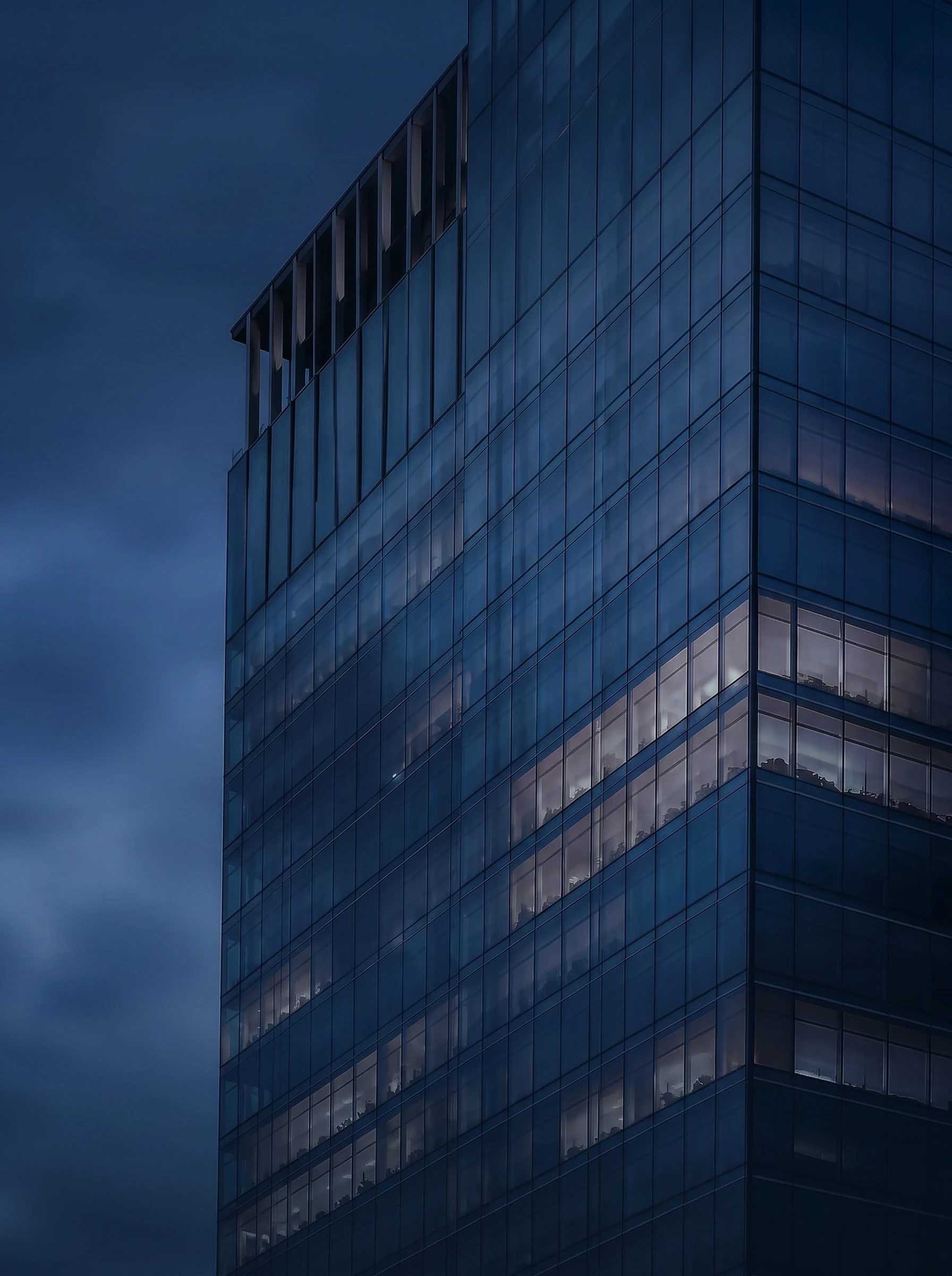 High-rise architectural glass façade reflecting the evening sky
